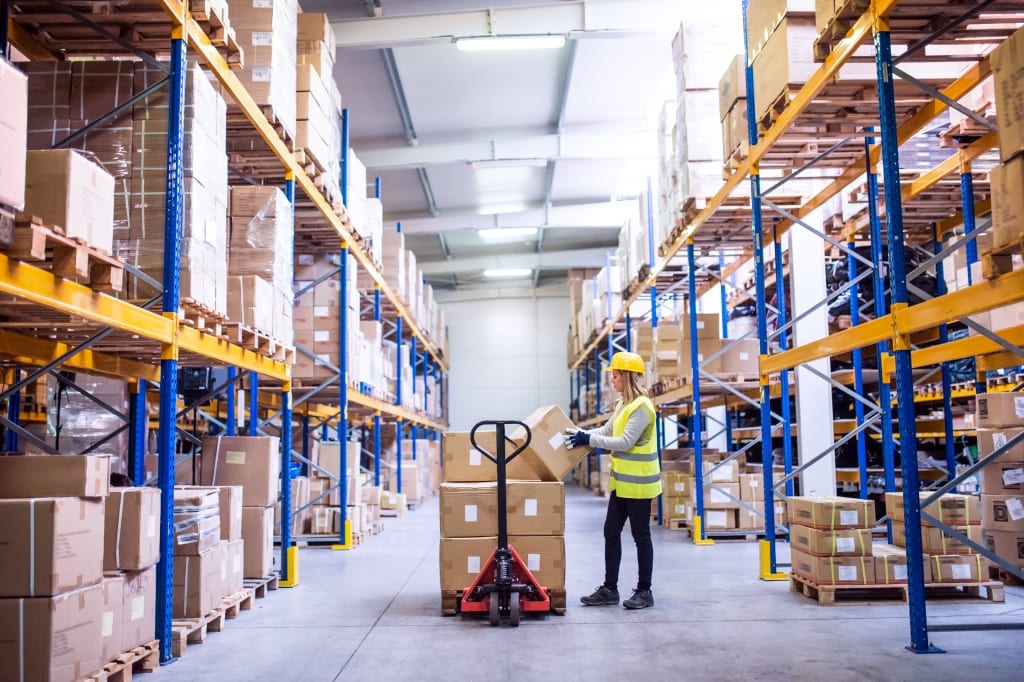 Female warehouse worker loading boxes. Female warehouse worker loading boxes.