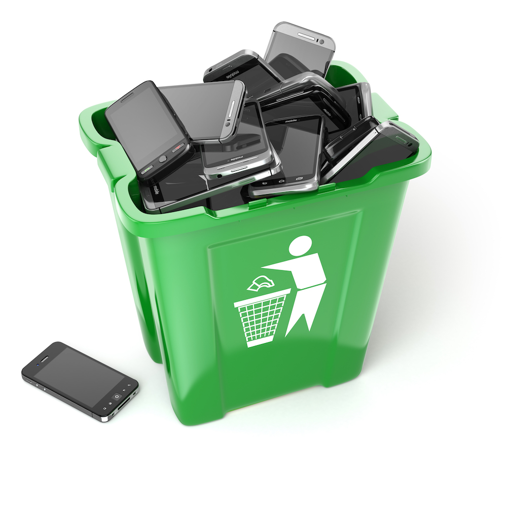 Mobile phones in garbage can isolated on white background. Utilization cellphones concept.