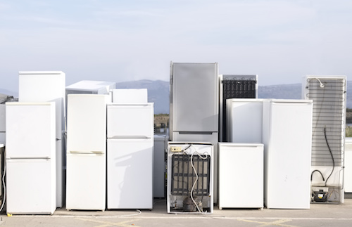 Old fridges freezers refrigerant at refuse dump skip recycle plant help environment