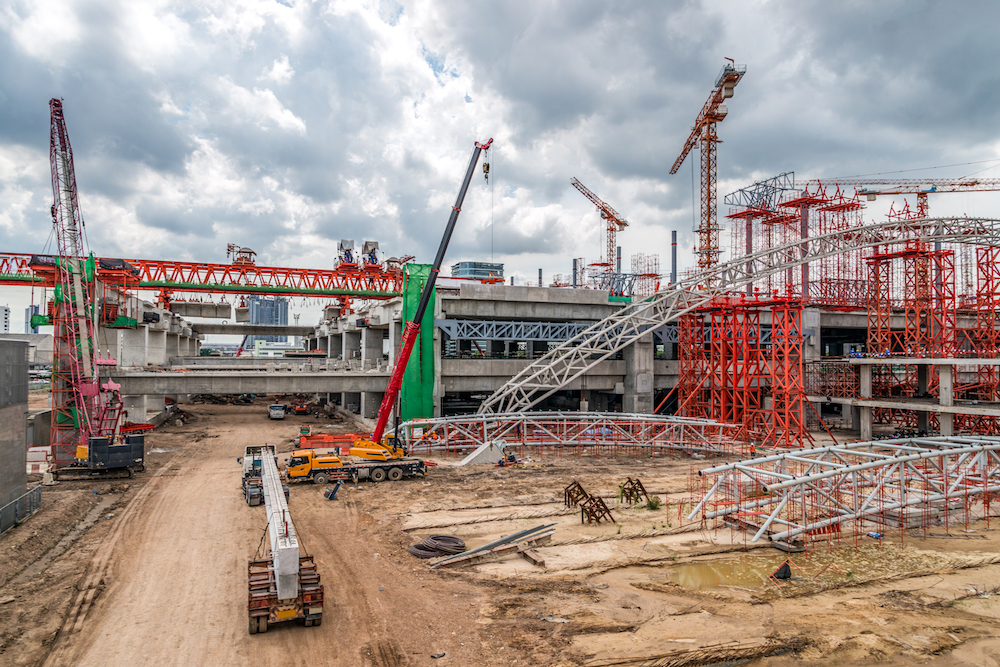 Construction Cranes Working on Expressway and Skytrain Site in Asia