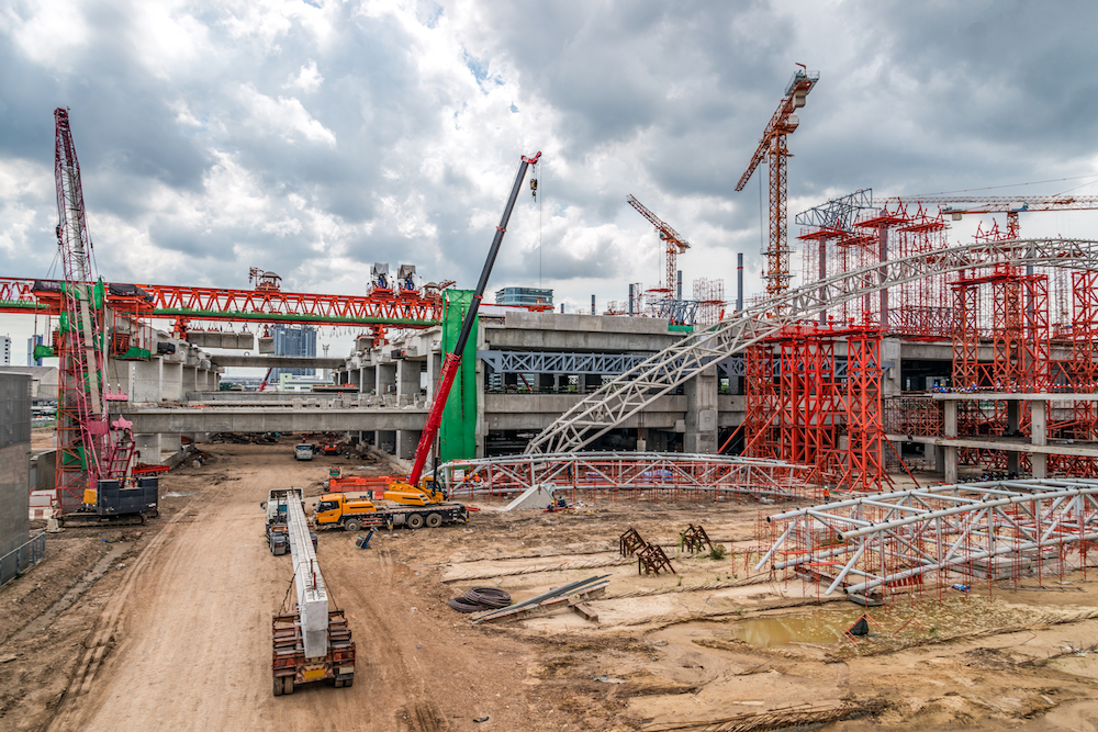 Construction Cranes Working on Expressway and Skytrain Site in Asia