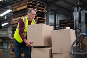 worker carrying cardboard boxes worker carrying cardboard boxes