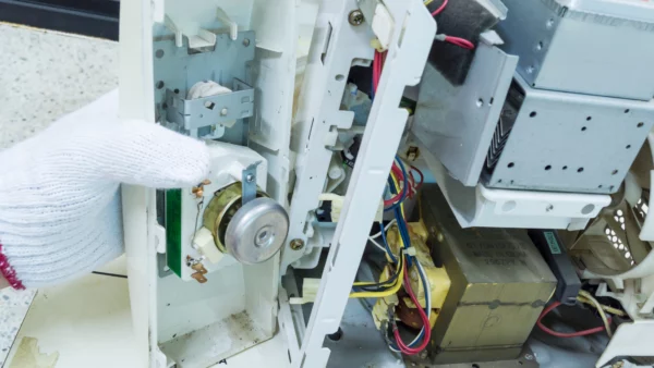 An old microwave being dismantled for recycling